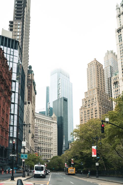 Free A vibrant street scene capturing Manhattan's iconic skyscrapers and urban life on a cloudy day. Stock Photo