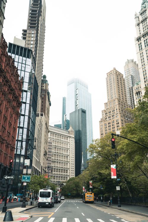 Free Iconic New York City street scene featuring towering skyscrapers and classic urban architecture. Stock Photo