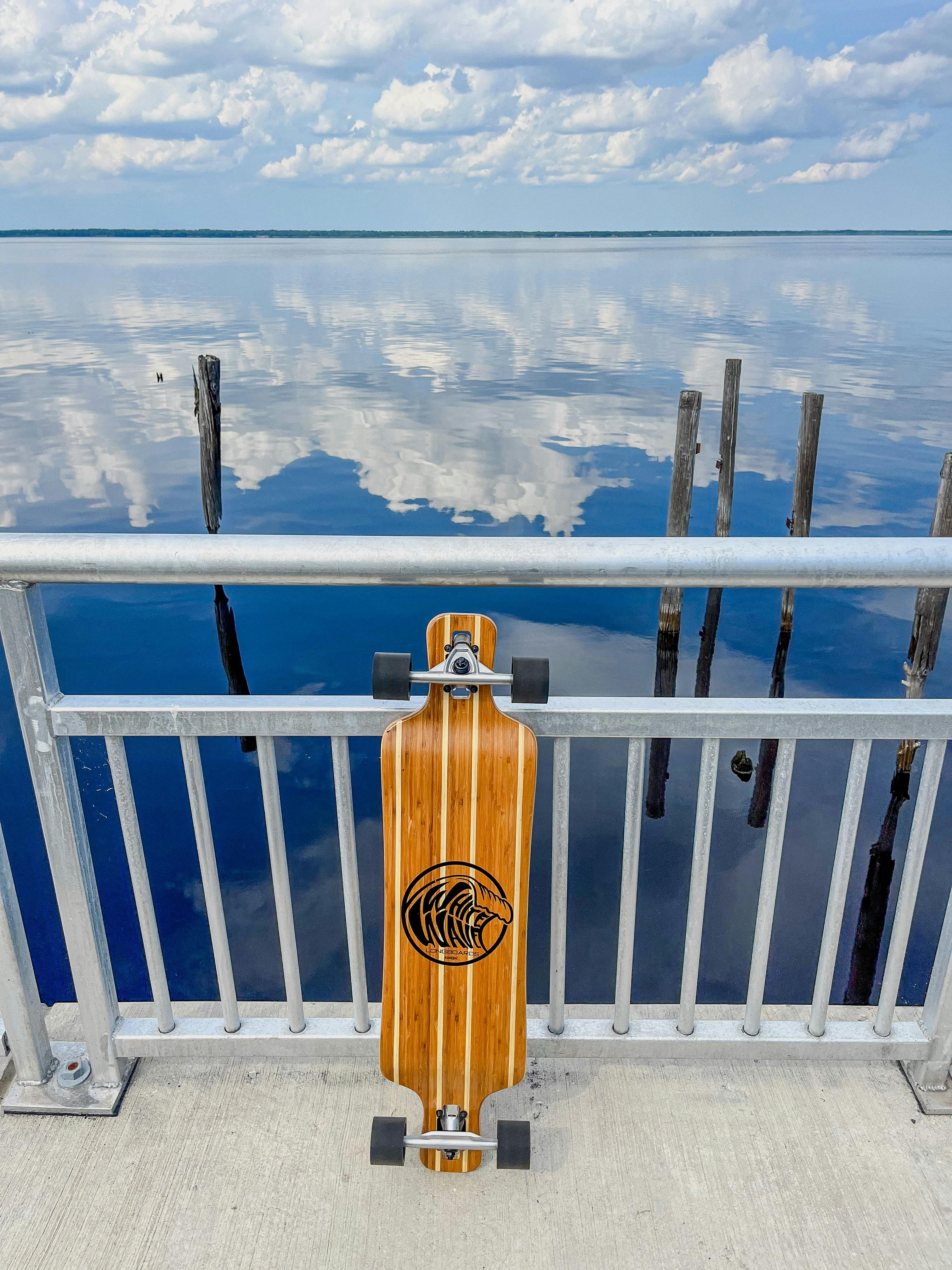 Skateboard on Railing by Water · Free Stock Photo