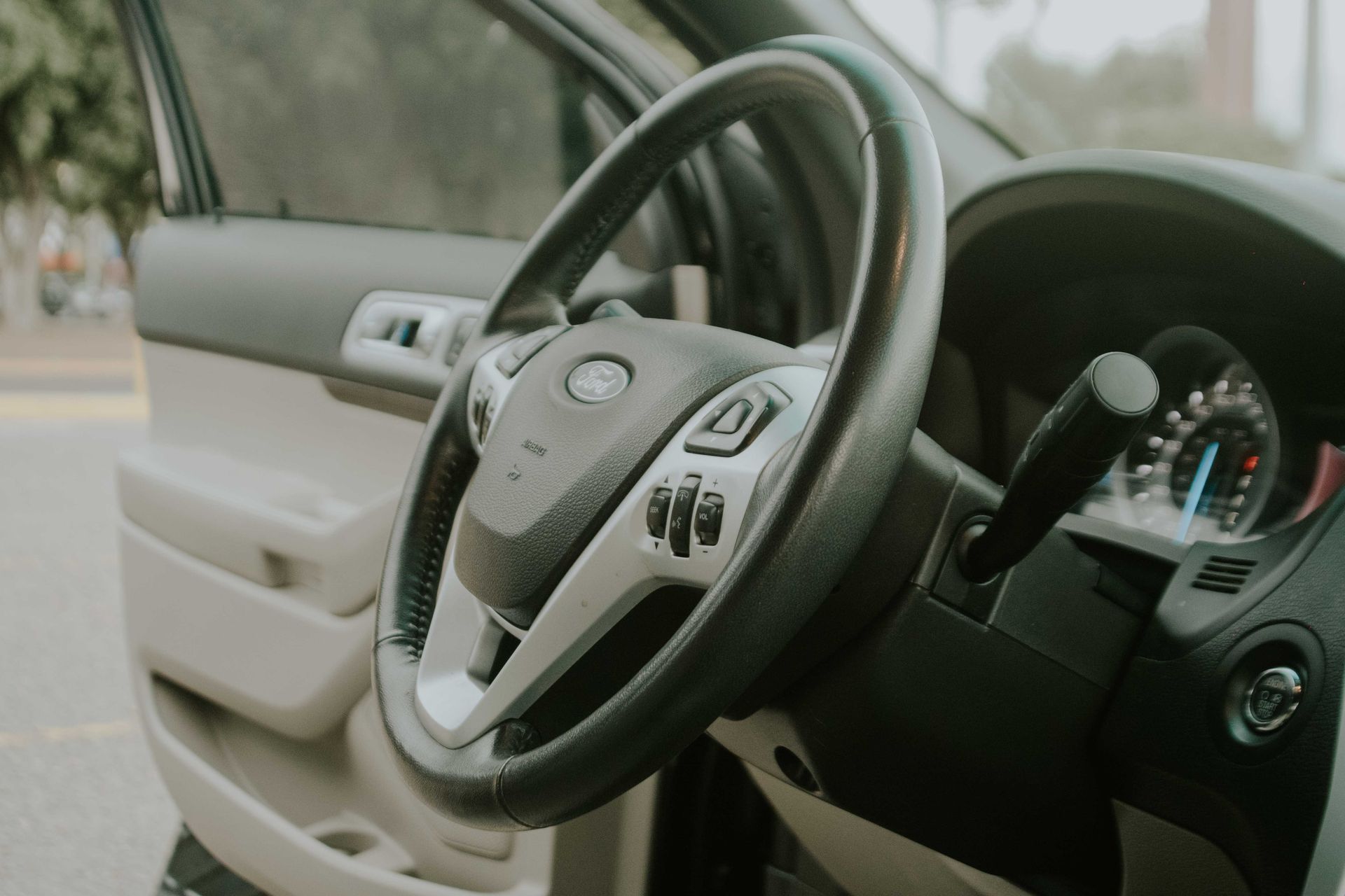 Detailed view of a Ford vehicle interior focusing on the steering wheel and dashboard.