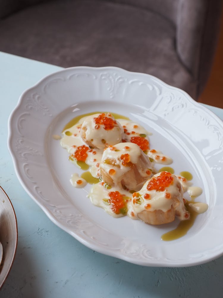 Food With Creamy Sauce On An Oval Ceramic Plate