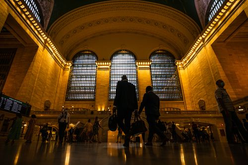 Free View of people walking inside the illuminated Grand Central Terminal in New York City. Stock Photo