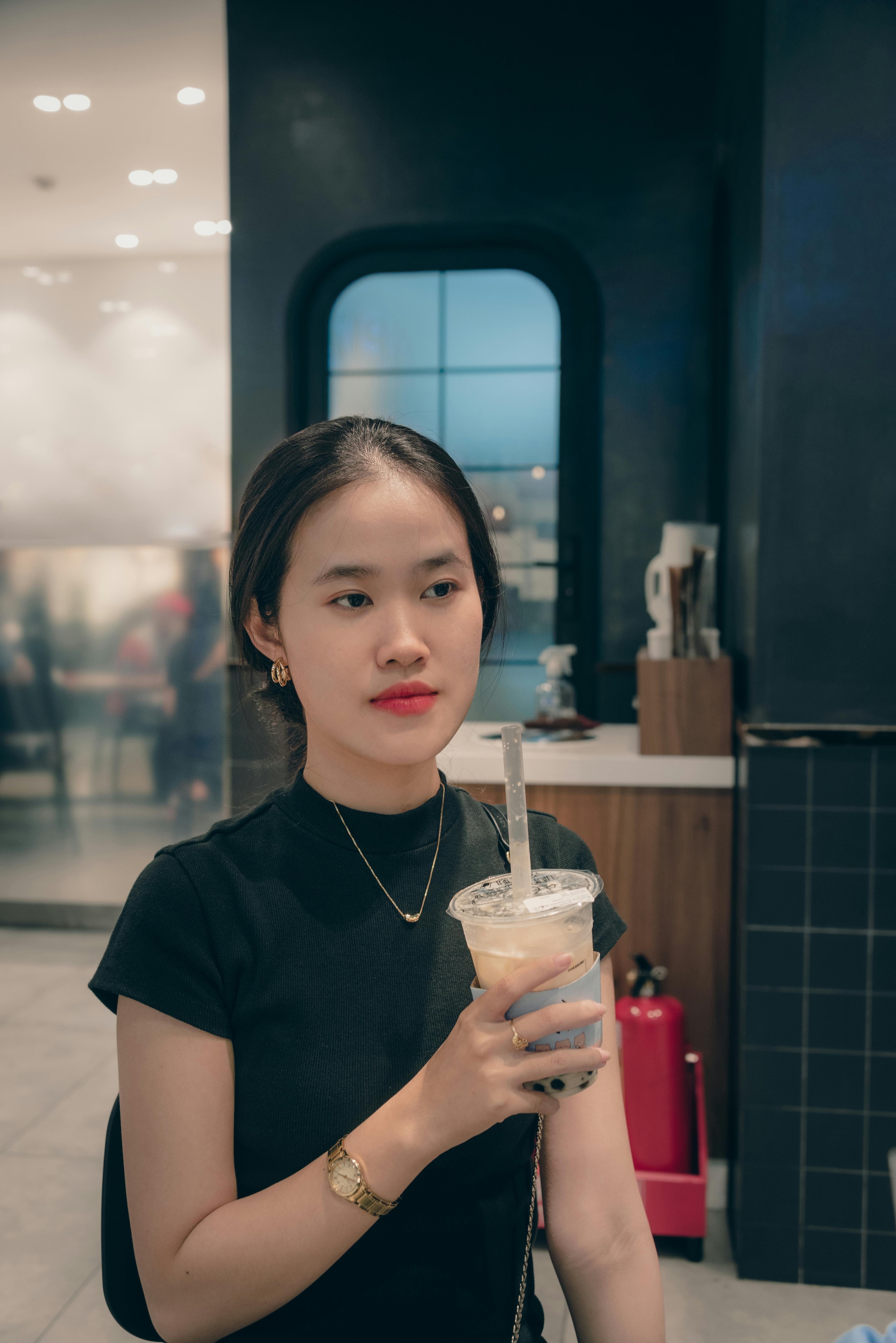 beautiful woman holding a cup of milk tea