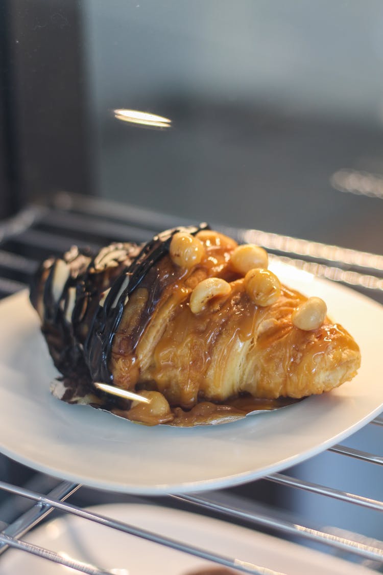 A Croissant With Chocolate And Caramel Syrup