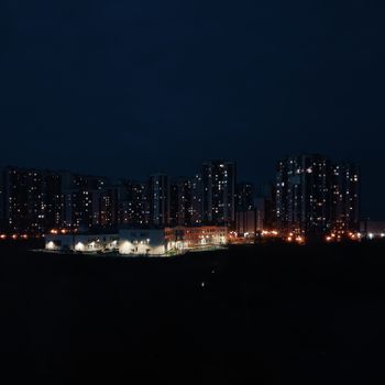 Captivating view of an urban skyline illuminated by city lights at night.
