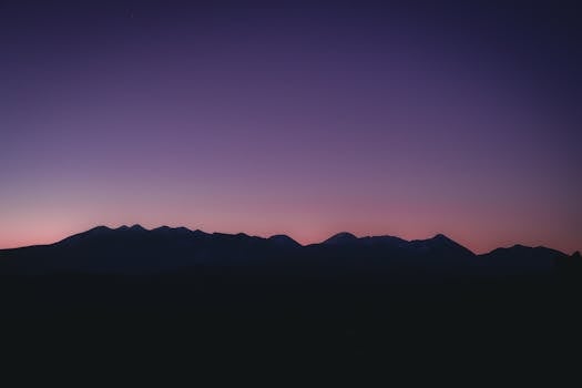 Captivating twilight mountain silhouette in Moab, UT with a serene evening sky.