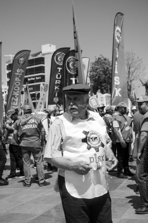 Free Monochromatic image of a senior man in an outdoor demonstration, holding a flag. Stock Photo