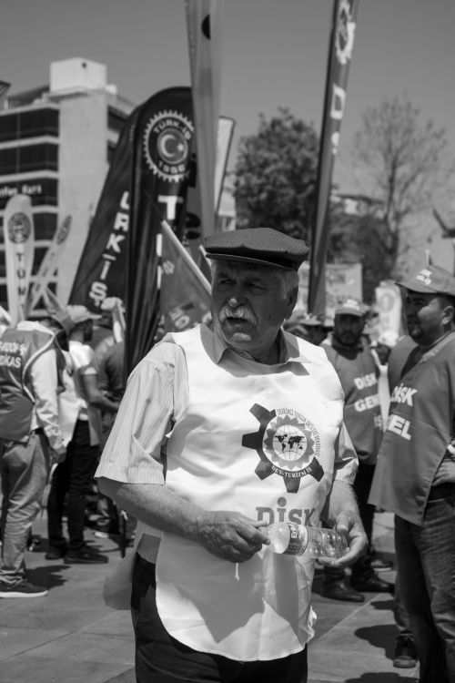 Free Senior man at an outdoor protest with banners, black and white photo. Stock Photo