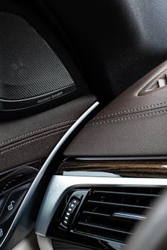 Close-up of a luxury car interior showcasing premium leather and sleek design elements.