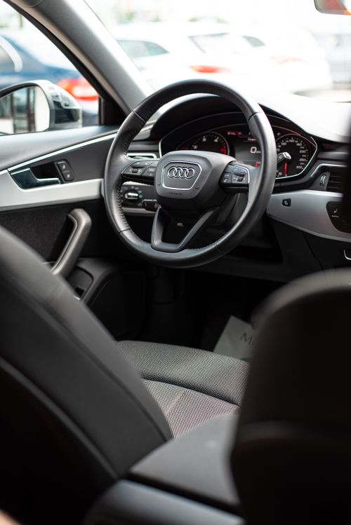 Free Interior view of a modern vehicle focusing on the steering wheel and dashboard. Stock Photo