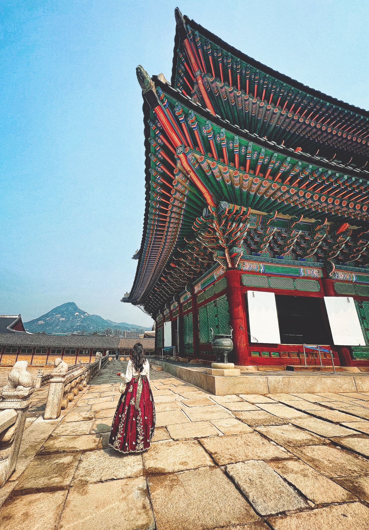 A visitor in traditional hanbok clothing at Gyeongbokgung Palace, Seoul