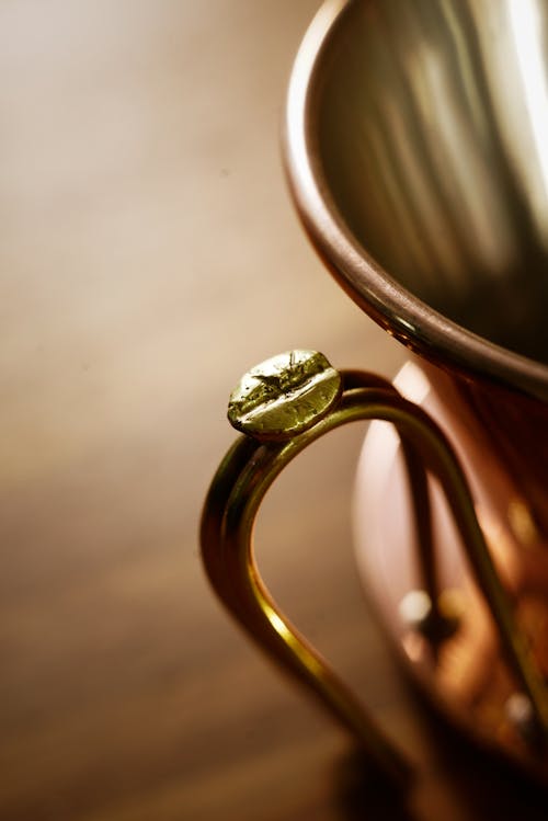 A Kettle with Coffee Bean Design on Handle