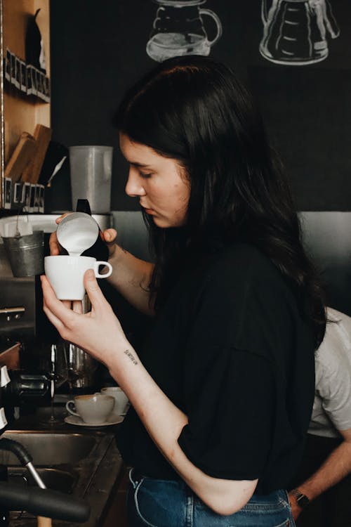 Free Woman in Black Shirt Holding White Ceramic Mug Stock Photo