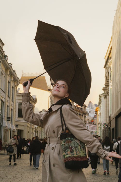 Beautiful Woman in Brown Coat Holding an Umbrella