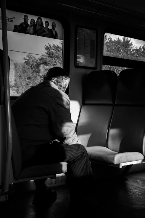 A Man in Black Jacket Sitting in the Train