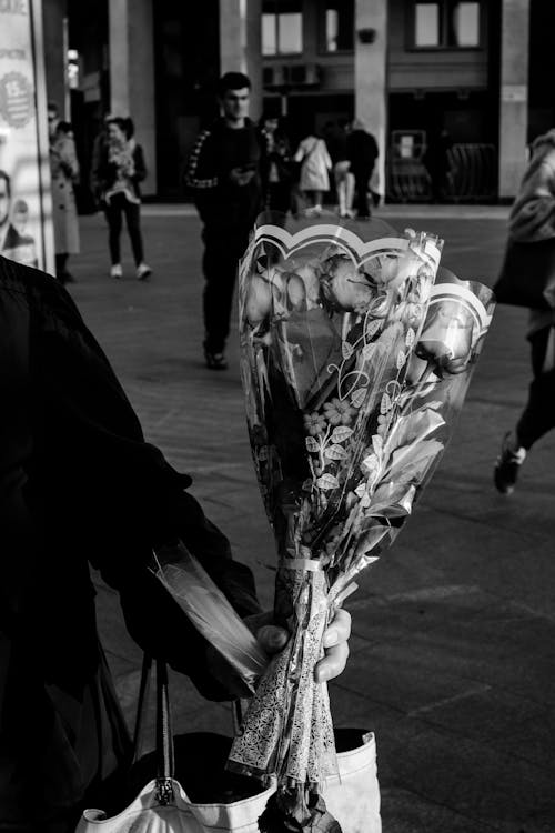 A Person Holding Bouquet of Roses