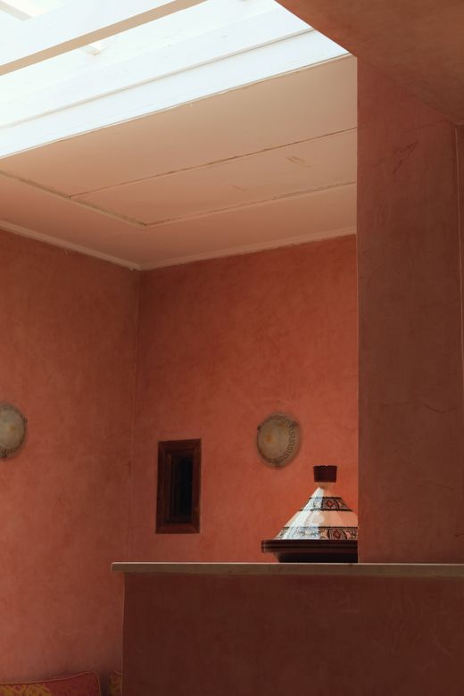 Terracotta-plastered room lit by a long skylight — photo by A. on Pexels