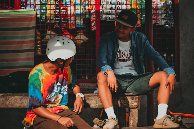 Men Talking To Each Other In Front Of A Store