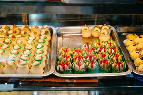 Free A colorful assortment of cookies and pastries in a café display case. Stock Photo