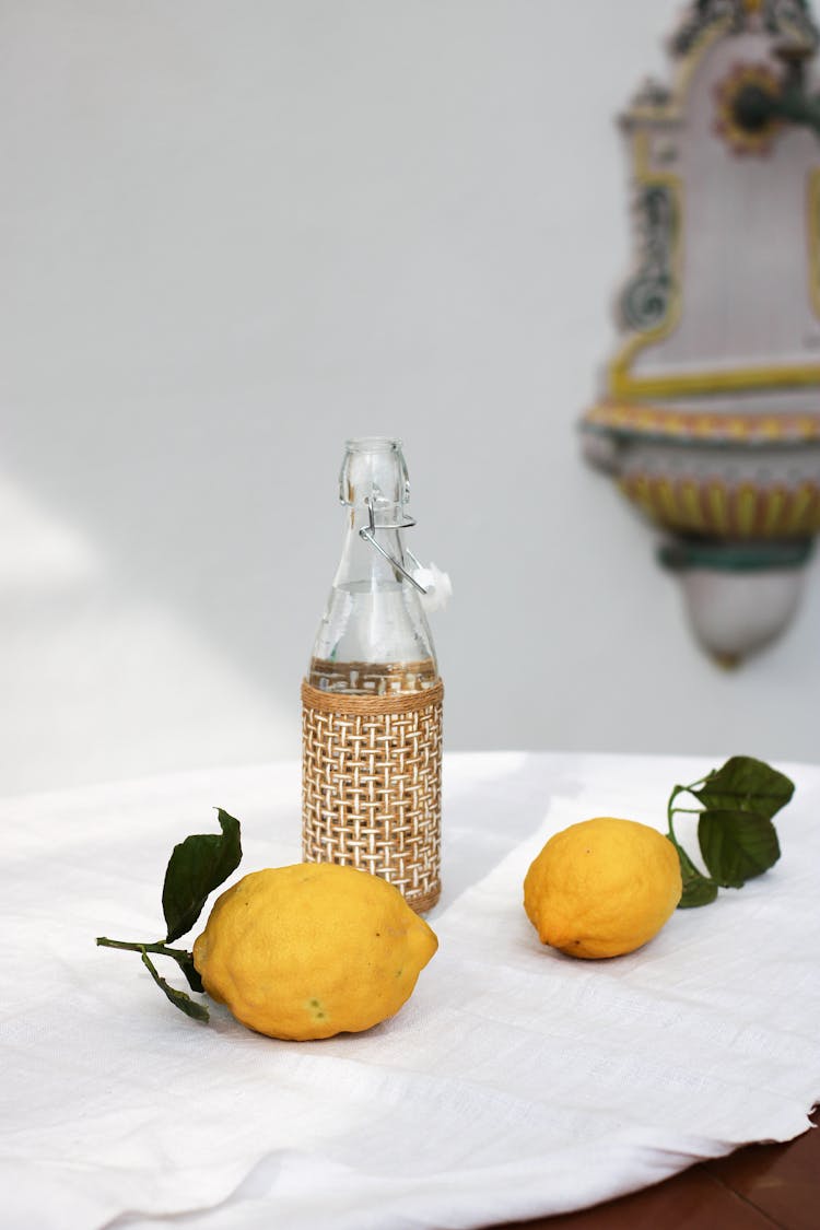 Lemons And A Clear Bottle On A Table