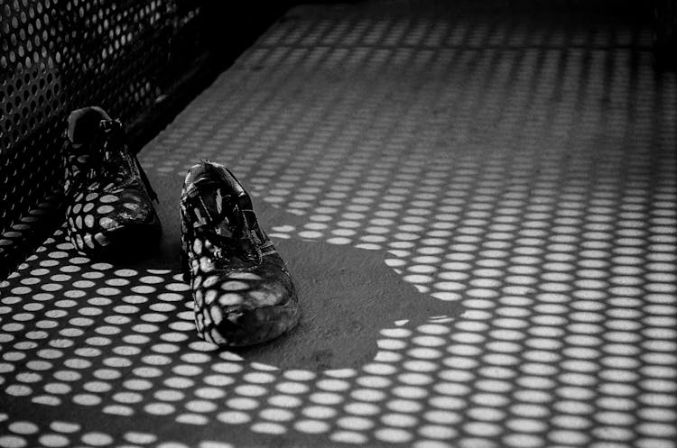 Black And White Photo Of Shoes On The Ground