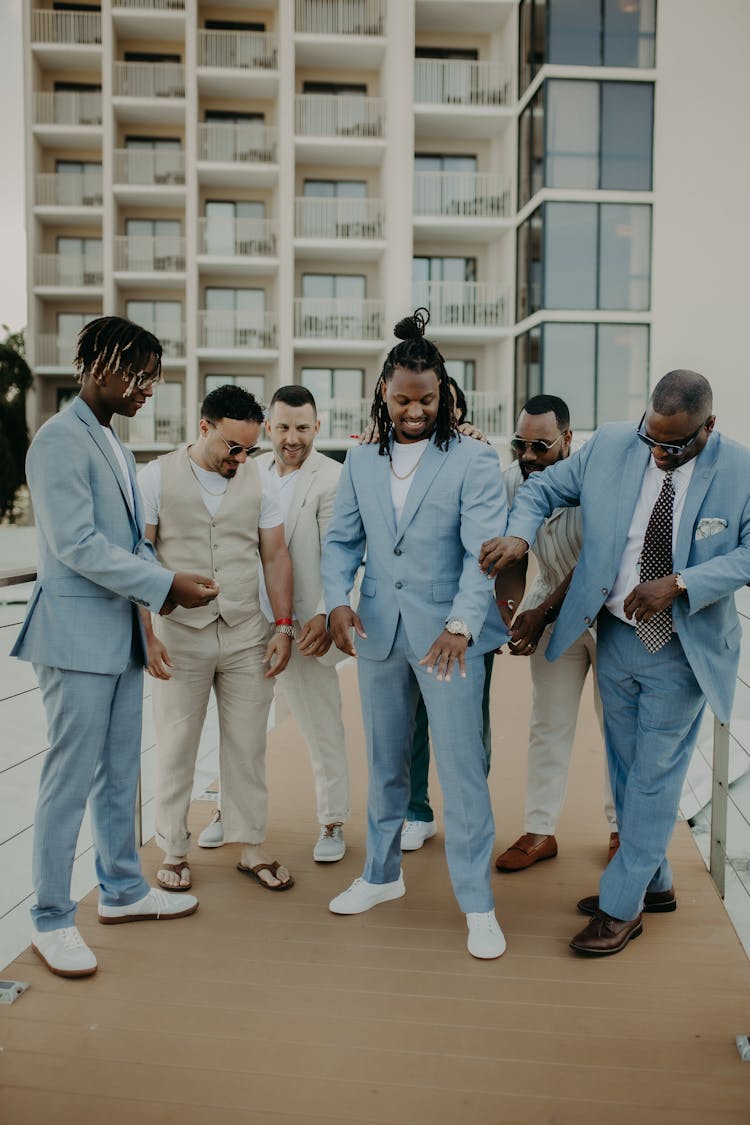 Group Of Elegant Men In Blue And Beige Suits 