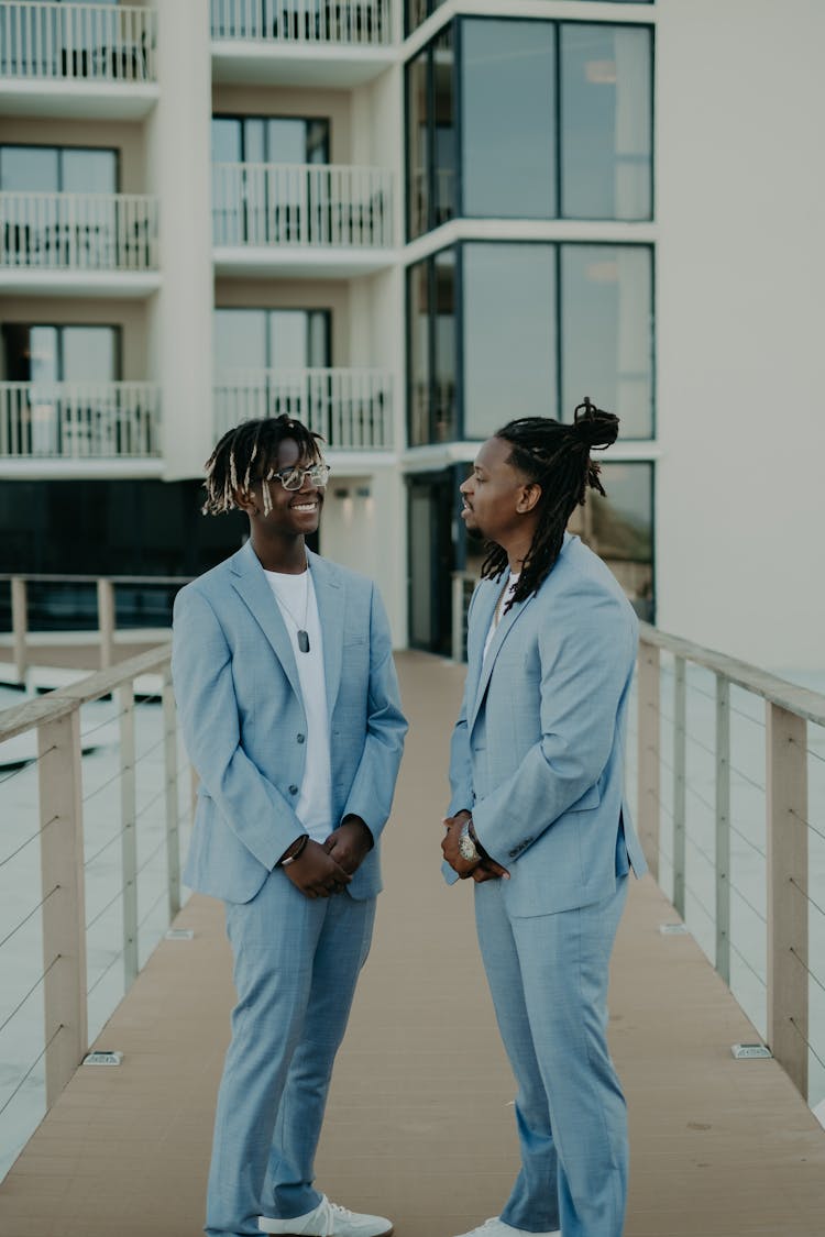 Two Young Men In Blue Suits 