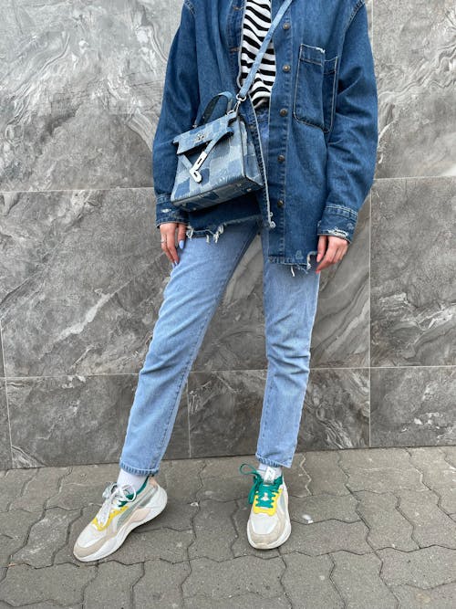 A Woman Wearing Denim Jacket and Denim Jeans