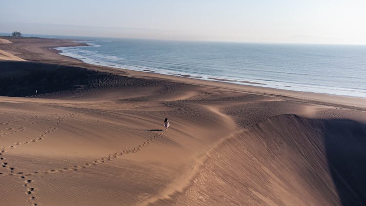 A Person Walking On Sand At Mujer Caminando En Dunas In Mexico