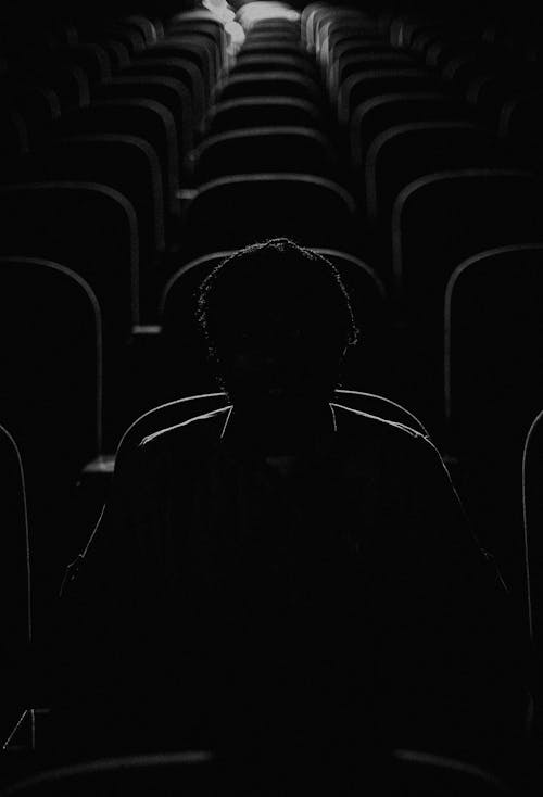 Free Silhouette of Man Sitting in Dark Cinema Stock Photo