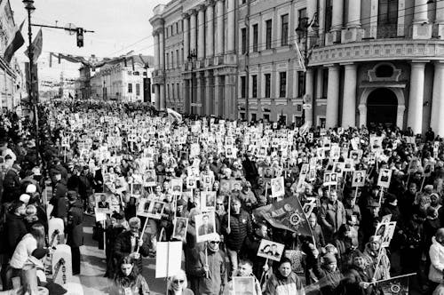 Grayscale Photo of People Rallying