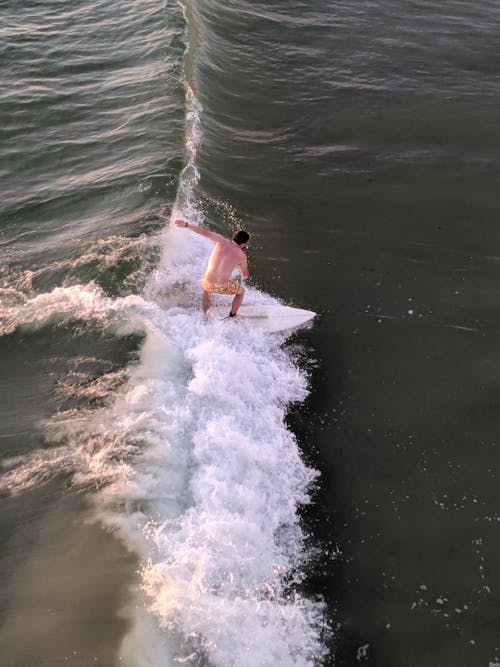 Free High Angle View of a Man Surfing Stock Photo