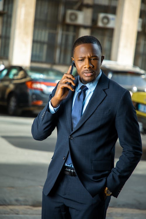 Man in Blue Suit Talking on the Phone