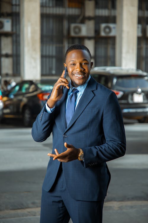Person in Blue Suit Talking on the Phone