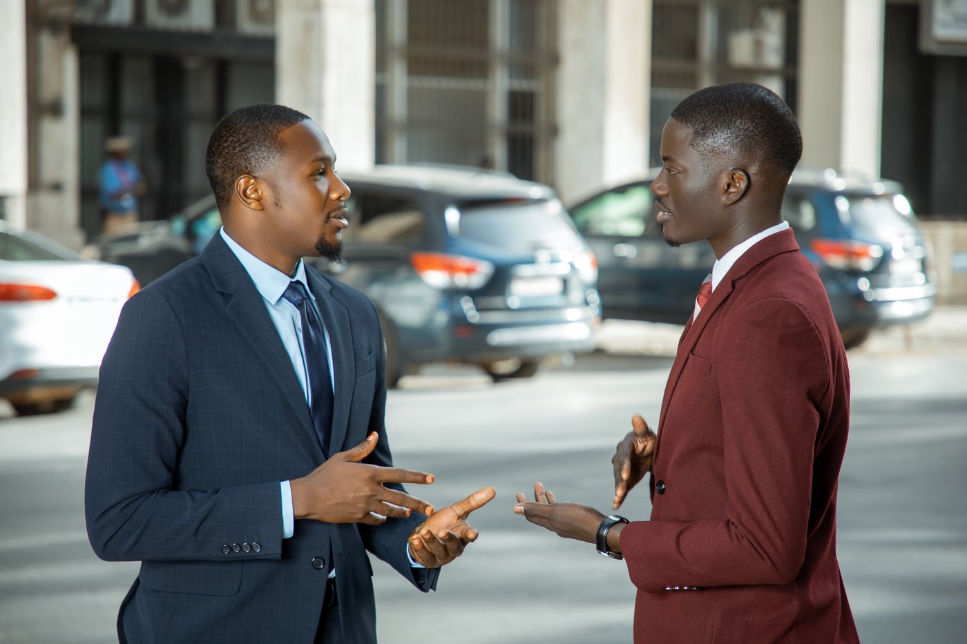 Two people talking on a city street