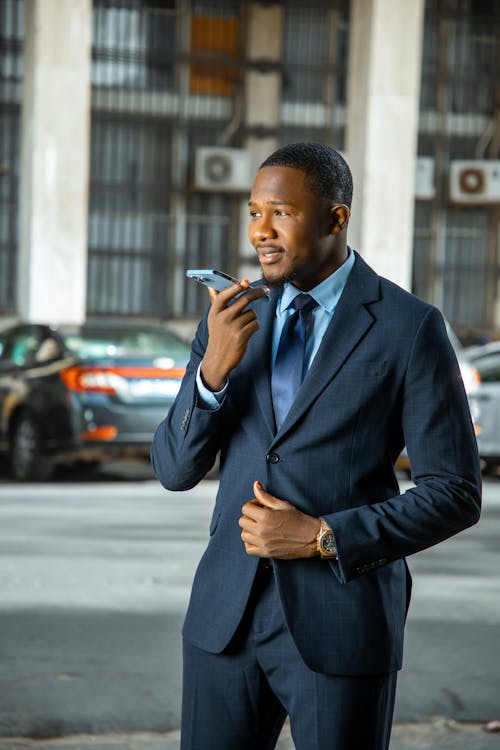 Man in Black Suit Jacket Holding Smartphone