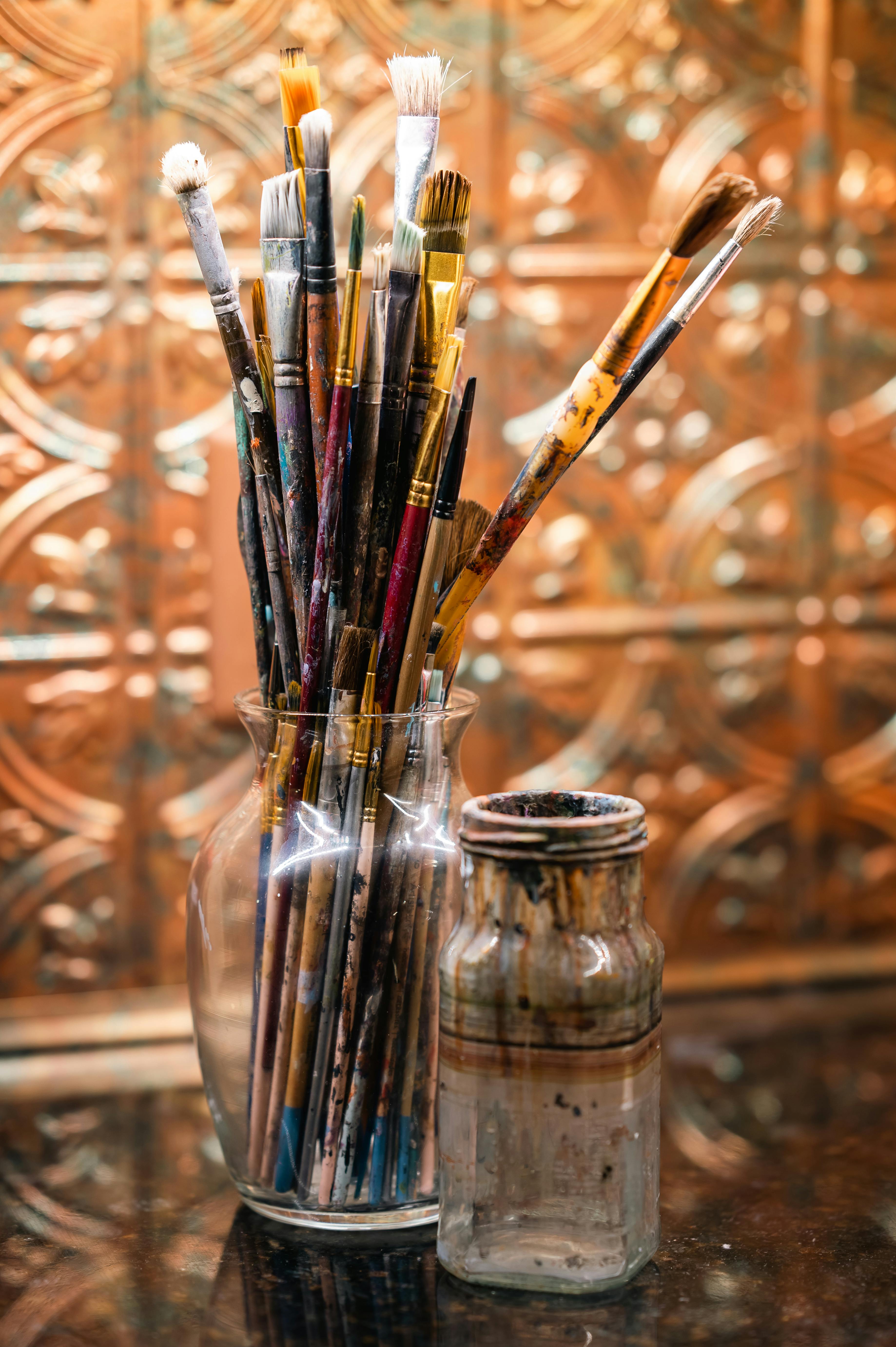 Close up of artist's paintbrushes in jars with artsy bohemian vintage  background Stock Photo - Alamy