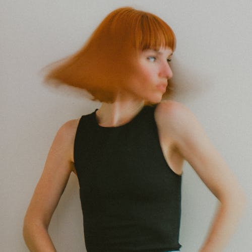 Woman Wearing Black Sleeveless Top on White Background