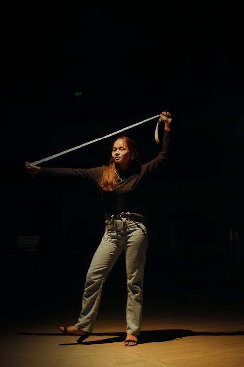 Woman with Tape Dancing in Dark