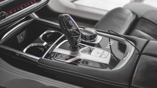 Close-up of a luxury car's gearshift in a sleek and modern interior design.