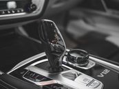 Close-up of a luxury car gearshift in a sleek, modern vehicle interior, highlighting advanced automotive technology.