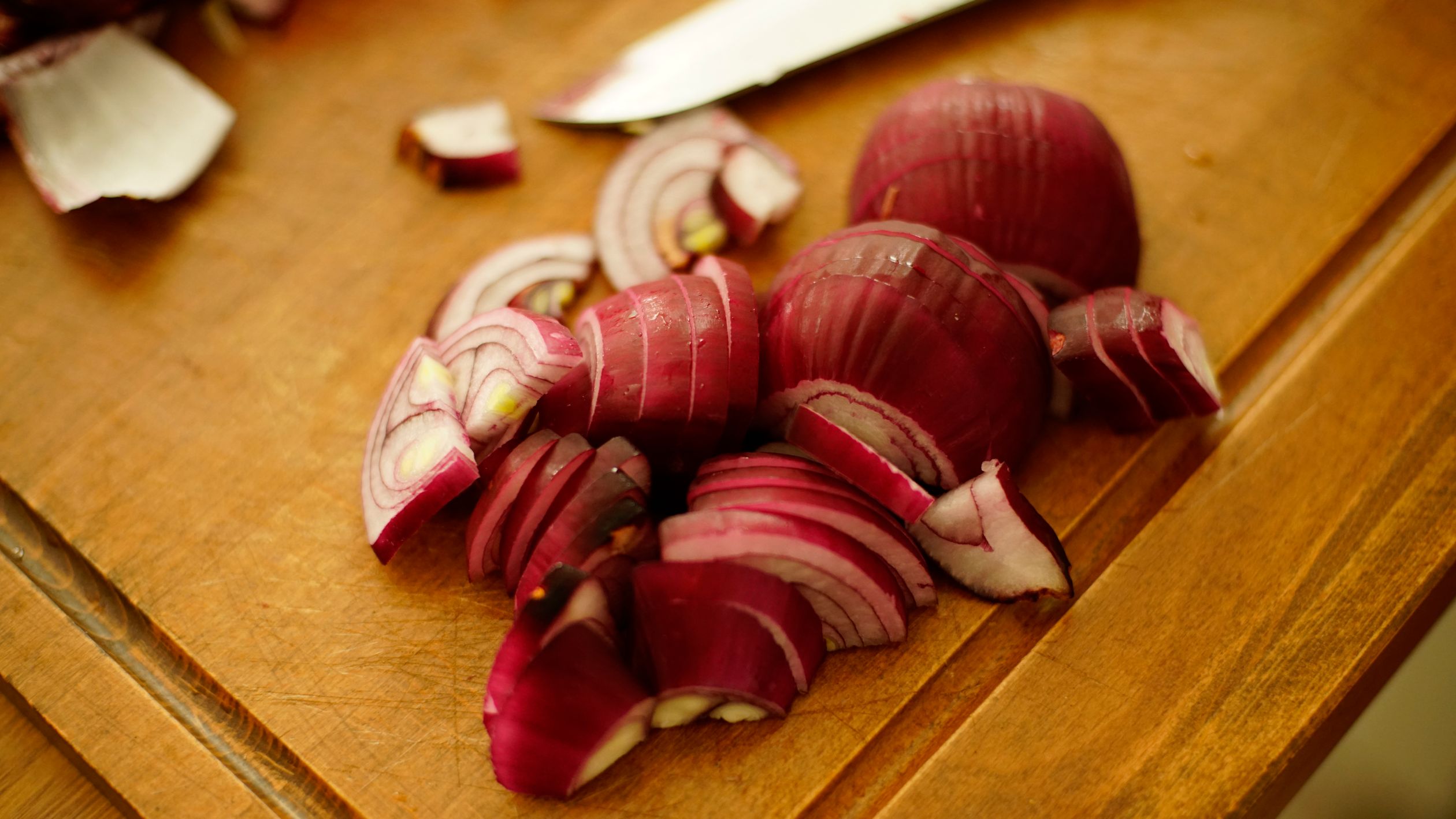 Sliced Red Onions on Brown Wooden Chopping Board