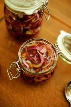Pickled onions packed into jars, seen from above, photo by Cihan Yuce on Pexels