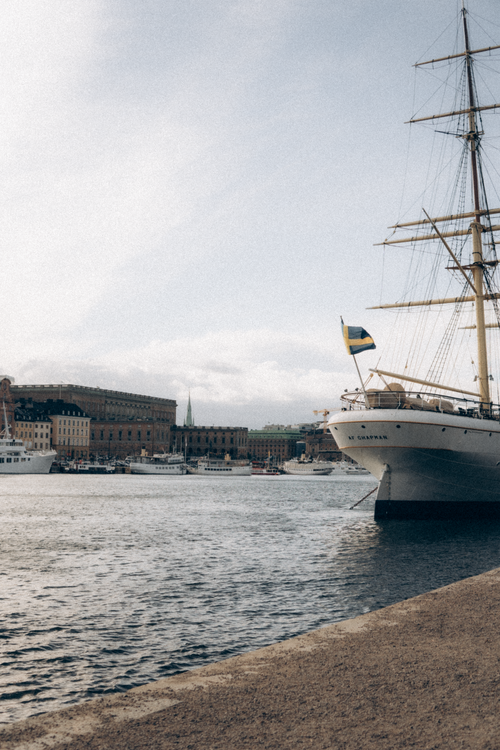 Free A classic sailing ship docked in Nybroviken Bay, Stockholm, Sweden under a cloudy sky. Stock Photo
