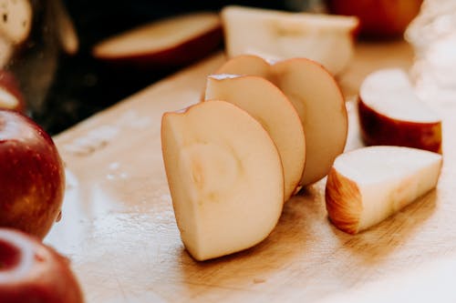 Slices of Red Apples on Wooden Surface