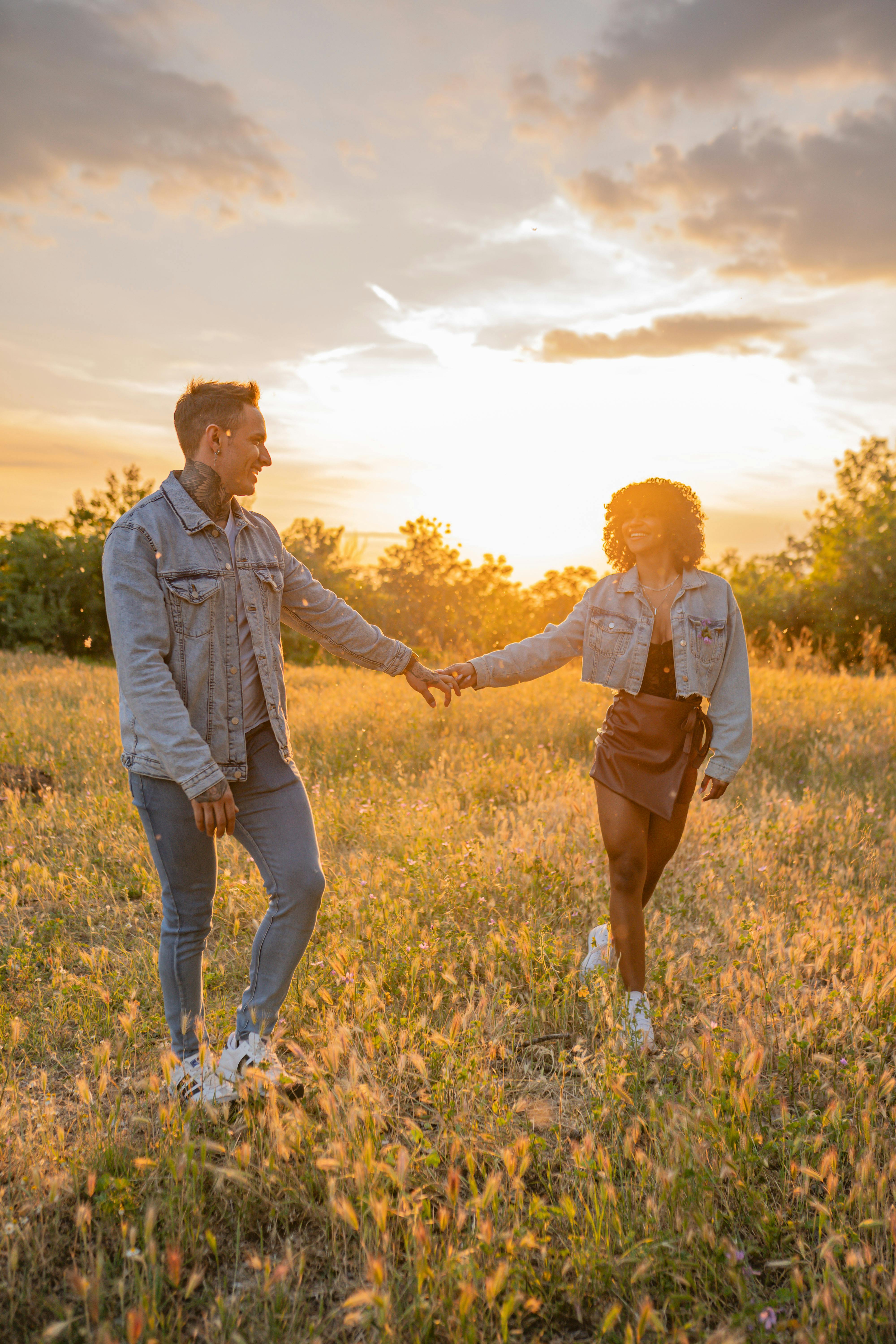 Couple Holding Hands on Meadow · Free Stock Photo
