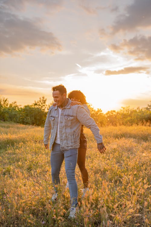 A Couple in a Field at Sunset