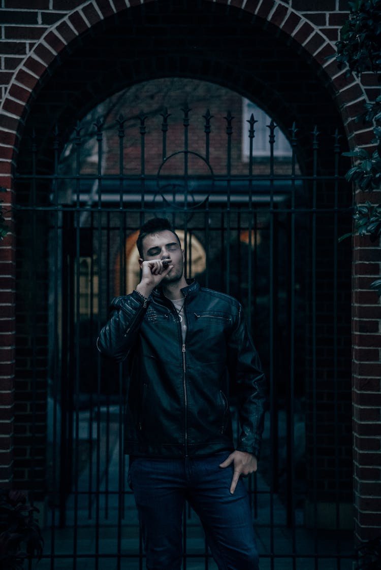 Man Smoking Cigar In Gate