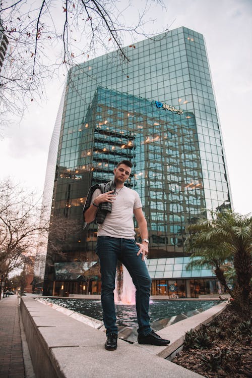 Man Posing Against Skyscraper