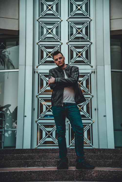 Man in Black Leather Jacket and Blue Denim Jeans